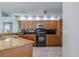 Charming kitchen features wood cabinets, granite countertops, and stainless steel appliances at 4951 Musselshell Dr, New Port Richey, FL 34655
