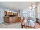 Kitchen and dining area with wood cabinets, granite countertops, and chandelier at 4951 Musselshell Dr, New Port Richey, FL 34655