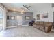 Cozy living room with tile flooring, a ceiling fan, and neutral paint at 4951 Musselshell Dr, New Port Richey, FL 34655