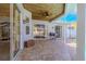 Covered patio with brick pavers, offering a cozy outdoor space with pool access and ceiling fan at 4951 Musselshell Dr, New Port Richey, FL 34655