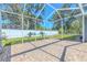 Relaxing screened patio with brick pavers and ample space for outdoor enjoyment with backyard view at 4951 Musselshell Dr, New Port Richey, FL 34655
