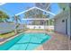 Screened-in pool area with a brick patio and a view of the home's exterior at 4951 Musselshell Dr, New Port Richey, FL 34655