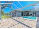 Exterior view of pool and patio area featuring a grill and multiple access points to the home at 4951 Musselshell Dr, New Port Richey, FL 34655