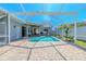 Spacious screened-in pool area with a brick patio and access to the home's interior at 4951 Musselshell Dr, New Port Richey, FL 34655