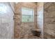 Modern shower with a built-in seat and decorative tile at 4951 Musselshell Dr, New Port Richey, FL 34655