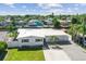 An aerial view of a waterfront property with lush greenery and neighborhood views at 5816 Liverpool Dr, Tampa, FL 33615