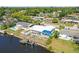 Aerial shot of a beautiful waterfront home with a pool, private dock, lush trees and residential neighborhood at 5816 Liverpool Dr, Tampa, FL 33615