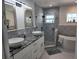 This bathroom has dual sinks with granite countertop, patterned tile walls, glass shower, and soaking tub at 5816 Liverpool Dr, Tampa, FL 33615