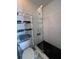 Modern bathroom featuring a glass-enclosed shower with subway tile and chrome fixtures at 5816 Liverpool Dr, Tampa, FL 33615
