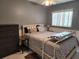Bedroom featuring a comfortable bed with a patterned comforter, dresser, and a bright window at 5816 Liverpool Dr, Tampa, FL 33615