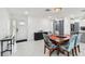 Dining area with modern decor featuring an entry door, and access to the kitchen at 5816 Liverpool Dr, Tampa, FL 33615