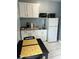 Cozy kitchen with white cabinetry, modern appliances, and a dining area at 5816 Liverpool Dr, Tampa, FL 33615