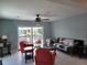 Cozy living room featuring bright decor, a ceiling fan, and serene water views at 5816 Liverpool Dr, Tampa, FL 33615