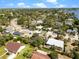 An aerial view of a quiet neighborhood with lush greenery and waterfront access on a sunny day at 660 Palm Ave, Tarpon Springs, FL 34689