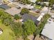 A sunny aerial perspective of homes with verdant lawns, and mature trees creating a private feel at 660 Palm Ave, Tarpon Springs, FL 34689