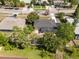 An elevated view showcasing a home surrounded by trees with a lawn, patio, and fence at 660 Palm Ave, Tarpon Springs, FL 34689