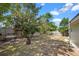 Backyard featuring mature trees and a wooden fence at 660 Palm Ave, Tarpon Springs, FL 34689