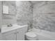 Updated bathroom featuring stylish gray tile surround and a modern vanity at 660 Palm Ave, Tarpon Springs, FL 34689