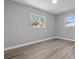 Bright bedroom featuring a view and wood floors at 660 Palm Ave, Tarpon Springs, FL 34689