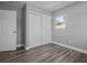 Cozy bedroom boasts wood-look floors and closet space at 660 Palm Ave, Tarpon Springs, FL 34689