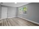 Cozy bedroom featuring a window with a view, freshly painted grey walls and modern flooring at 660 Palm Ave, Tarpon Springs, FL 34689