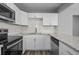 Bright kitchen featuring white cabinets, stainless steel appliances, and modern finishes at 660 Palm Ave, Tarpon Springs, FL 34689