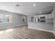 Open concept kitchen and living area featuring modern appliances, white cabinetry, and beautiful hardwood floors at 660 Palm Ave, Tarpon Springs, FL 34689