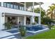 Beautiful backyard featuring a modern pool, luxurious patio, and covered outdoor kitchen at 721 Brightwaters Ne Blvd, St Petersburg, FL 33704