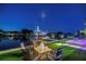 Picturesque night scene of a waterfront property with a fire pit, dock, and boat at 721 Brightwaters Ne Blvd, St Petersburg, FL 33704