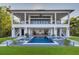 Stunning backyard with a modern pool, lush landscaping, and covered patio at 721 Brightwaters Ne Blvd, St Petersburg, FL 33704