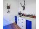 A bar with white countertops and blue cabinets at 721 Brightwaters Ne Blvd, St Petersburg, FL 33704