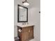 This is a bright bathroom with white walls and a wooden vanity at 721 Brightwaters Ne Blvd, St Petersburg, FL 33704