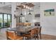 Open dining area with rustic wood table, seating, and access to a modern, bright kitchen at 721 Brightwaters Ne Blvd, St Petersburg, FL 33704