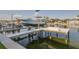 Boat dock with a boat lift showing waterfront access and views of luxury homes at 721 Brightwaters Ne Blvd, St Petersburg, FL 33704