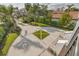 Wide driveway featuring a grass diamond shape surrounded by brick and landscaping at 721 Brightwaters Ne Blvd, St Petersburg, FL 33704