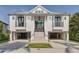 Stunning two-story coastal home with a grand entrance, double garages, and meticulous landscaping at 721 Brightwaters Ne Blvd, St Petersburg, FL 33704