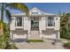 Stunning two-story home with a clean white facade, multi-car garage, and landscaped front yard at 721 Brightwaters Ne Blvd, St Petersburg, FL 33704