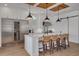 Modern kitchen with white cabinets, a central island, and stainless steel appliances, including a wine fridge at 721 Brightwaters Ne Blvd, St Petersburg, FL 33704
