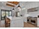 Modern kitchen with stainless steel appliances, island with bar seating, and wood-paneled ceiling at 721 Brightwaters Ne Blvd, St Petersburg, FL 33704