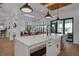 Bright kitchen featuring a large island, modern sink, and seamless flow to the living area at 721 Brightwaters Ne Blvd, St Petersburg, FL 33704