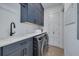 This is a laundry room featuring front loading appliances, cabinetry, and a utility sink at 721 Brightwaters Ne Blvd, St Petersburg, FL 33704