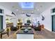 Open-concept living room with vaulted ceilings, skylight, and decorative fish mounts throughout the home at 721 Brightwaters Ne Blvd, St Petersburg, FL 33704