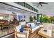 Living room with white couches and a table with a view overlooking the outdoor patio and waterfront at 721 Brightwaters Ne Blvd, St Petersburg, FL 33704