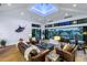 Spacious living room featuring a vaulted ceiling, skylight, and open floor plan overlooking the waterfront at 721 Brightwaters Ne Blvd, St Petersburg, FL 33704