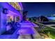 Luxurious backyard with a stunning pool, dock, and beautifully landscaped yard at night at 721 Brightwaters Ne Blvd, St Petersburg, FL 33704