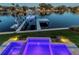Aerial view of luxurious pool and dock with boat in tranquil waterfront setting at 721 Brightwaters Ne Blvd, St Petersburg, FL 33704