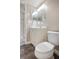 Bathroom features a white single sink vanity, toilet, and decorative mirror at 7645 Sun Island S Dr # 207, South Pasadena, FL 33707