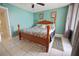 Relaxing bedroom with a wooden bed frame, tile floors, and natural light at 7645 Sun Island S Dr # 207, South Pasadena, FL 33707