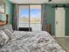Cozy bedroom with waterfront views and sliding barn door at 7645 Sun Island S Dr # 207, South Pasadena, FL 33707