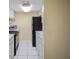 Galley kitchen features white appliances, countertops and cabinetry at 7645 Sun Island S Dr # 207, South Pasadena, FL 33707